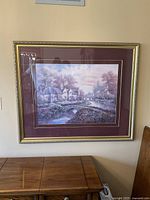 Front view of framed print showing the cottage scene and ornate frame.