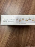 Front box image showing the product name and examples of cookie shapes possible with the device.