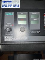 Close-up of Weslo treadmill console showing brand, digital displays and control buttons.