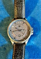 Close-up front view of the watch showing the dial with 24-hour indices and date window.