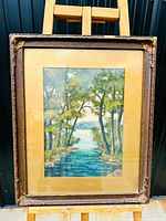 Full view of framed artwork showing the painting, gilded matting and frame.