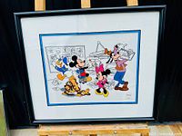 Full view of framed animation cel under plexiglass featuring Disney characters