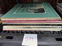 Side view of stacked vinyl albums showing album spines including Bach & Vivaldi Concertos and Beethoven symphonies.