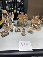 Photo showing all Boyds Bears Town Village pieces including buildings, bear figurines, and a miniature car arranged on a white surface.