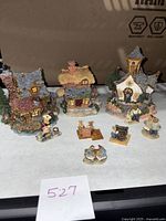 Boyd's Bears town village set showing houses and small bear figurines with miniature accessories on display
