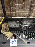 Black painted cast iron eagle wall hanging, bronze Huck Finn bookend, and silver plated letter opener on display surface