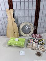 Wooden bunny cutout, wooden discs, lime green mesh, and multiple bags of beads