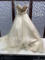 Front view of size 4 strapless formal dress from David's Bridal with embellished bodice and full tulle skirt.