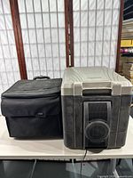 Foray black rolling laptop case next to Coleman 40Qt thermoelectric cooler showing overall size and condition