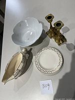 All items displayed: gravy boat, small snack plate, large serving bowl, and brass candle holders.