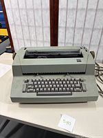 Front view of IBM Selectric 2 typewriter showing the full keyboard and paper feed roller area.