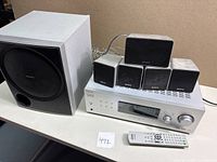 Sony audio system with subwoofer, 5 speakers and receiver unit on tabletop.