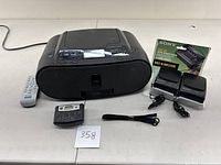 Sony Personal Audio System model zs-s2ip with remote, Walkman active speakers, and Walkman radio shown on tabletop.