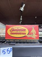 Original red and yellow Sunbeam Ironmaster box with vintage illustration and branding text.