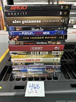 Stack of 16 used DVD cases showing titles and set details for identification