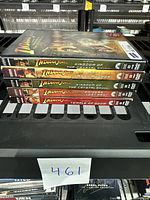 Five Indiana Jones DVD cases stacked horizontally showing spines with movie titles.