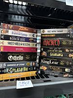 Photo shows stack of 15 VHS tapes with titles visible including Forrest Gump, Platoon, Full Metal Jacket, Othello, Macbeth and more.