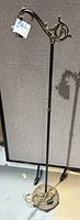 Full view of vintage cast iron floor lamp showing height, round base, and bridge arm design