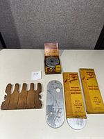 Full lot on table showing cutter head, blade set, and three boxed Delta table inserts