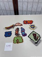 Various vintage 1970s sew on patches including characters, text, military and fantasy themed embroidery.