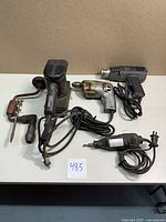 Overview of lot showing Sears Craftsman finishing sander, Dremel rotary tool, Black & Decker heat gun, Black & Decker utility drill, and vintage hand drill