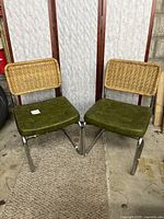 Two vintage kitchen chairs with rattan backs and avocado vinyl seats shown side by side, chrome metal legs, one chair with damaged rattan back.