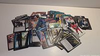 Top view of assorted trading cards spread on a flat surface, showing a variety of hockey, Yu-Gi-Oh, and Magic cards.
