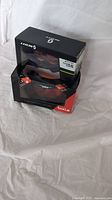 Two pairs of ski goggles in original packaging, one from Bolle and one from Scott, shown side by side.