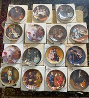 Fourteen Norman Rockwell collector plates in original boxes arranged on carpet. Plates depict various scenes by Rockwell.