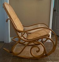 Side view showing scroll bentwood rockers and curved armrest profile