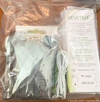 Sealed bag containing Revitive stimulation gel with ingredients and usage instructions visible on box.