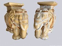 Front perspective of two ceramic elephants side by side showing overall design and coloration