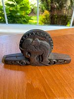 Front view of carved wooden elephant scale showing detailed elephant carving and circular weighing platform