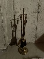 Full view of brass fireplace tool set with stand and all tools: shovel, brush, tongs, poker