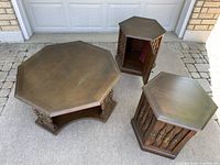 All three tables displayed outside on driveway; two side tables with open storage compartments visible, coffee table showing overall condition.