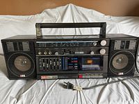 Front view of Aiwa CA-30 boom box with visible cassette player, controls, and speakers