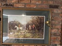 Photo of framed print with hunting scene and brass bugle mounted on the frame, showing dimensions and condition.