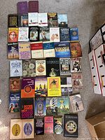 Overview of assorted occult, magic and esoteric books arranged on carpet