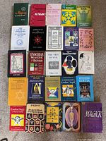 Overhead view of 25 occult and magic books arranged in grid