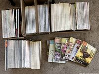 Four boxes packed with Martha Stewart Living magazines from the early 2000s, plus several issues displayed front-facing showing colorful covers related to home, garden, and lifestyle themes.