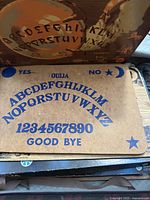 Front view of particleboard Ouija board printed in blue