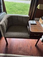 Front view of integrated chair and side table with lamp on top