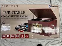 Front and top view of the Proscan stereo system box showing product features and visuals of the unit with open lid.