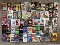 Wide shot showing the full assortment of VHS tapes arranged in rows displaying their cover art and titles.