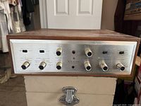 Front view of amplifier showing aluminum faceplate, control knobs and H.H. Scott logo