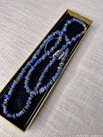 Necklace coiled inside presentation box