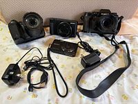 Overview of four cameras with accessories