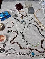 Overall view of mixed jewellery pieces and small boxes laid out