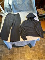 Front view of jogger pants and hooded top laid flat