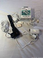 Overall lot view showing two Sony camcorders, two Apple iPods, DSW earbuds box and accessories